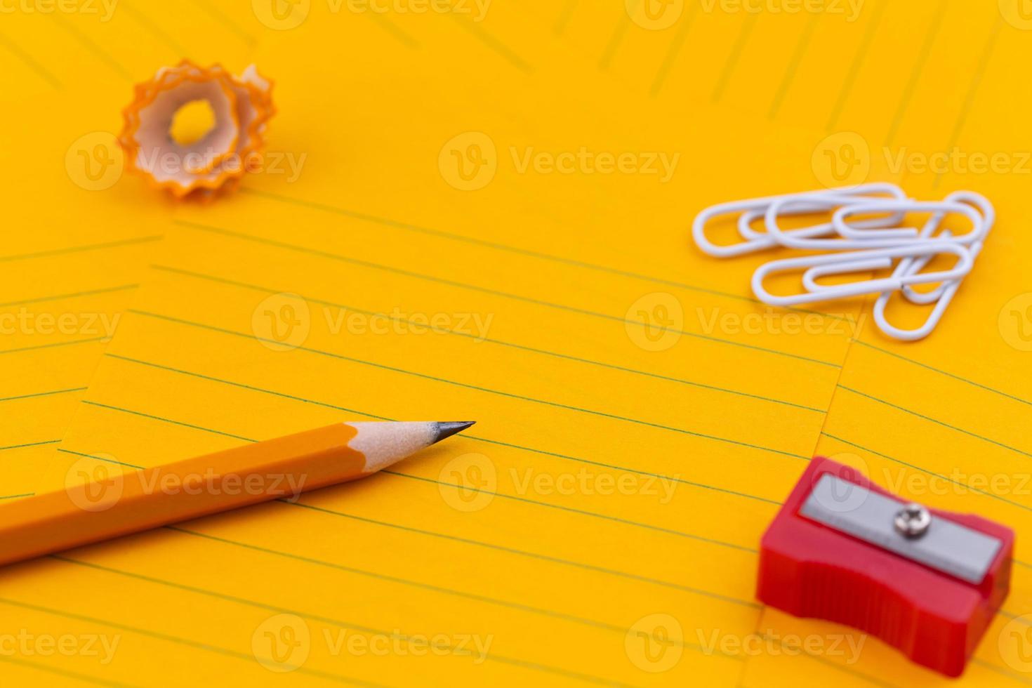 Orange sheets of paper pencil stationery and empty space for your text photo