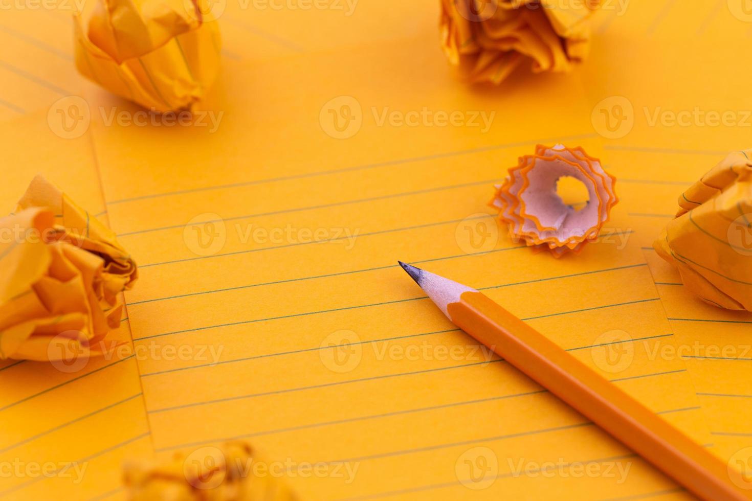 Orange sheets of paper pencil stationery and empty space for your text photo