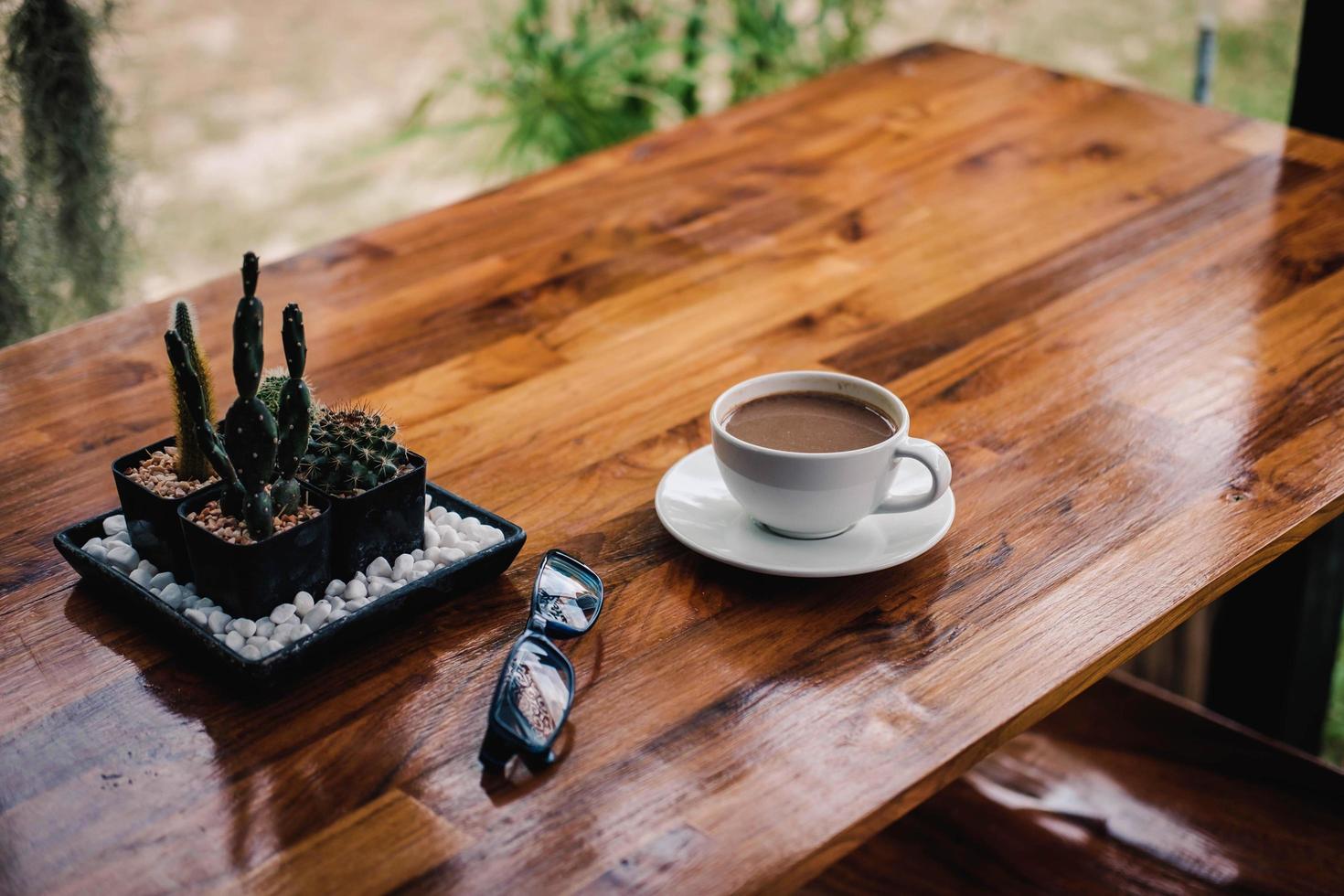 A cup of coffee on a wooden table in a coffee shop photo