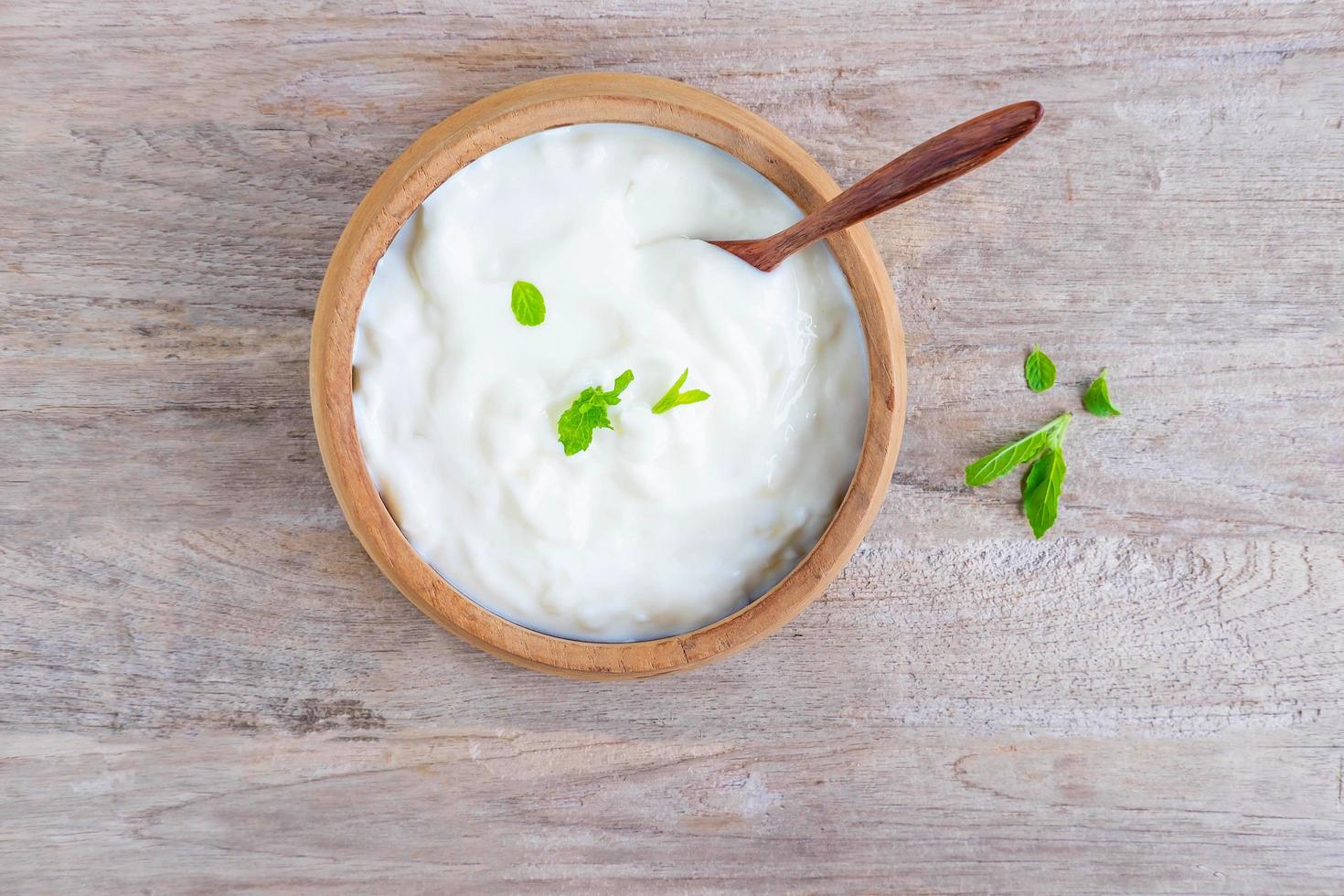 Healthy natural yoghurt on a wooden table photo