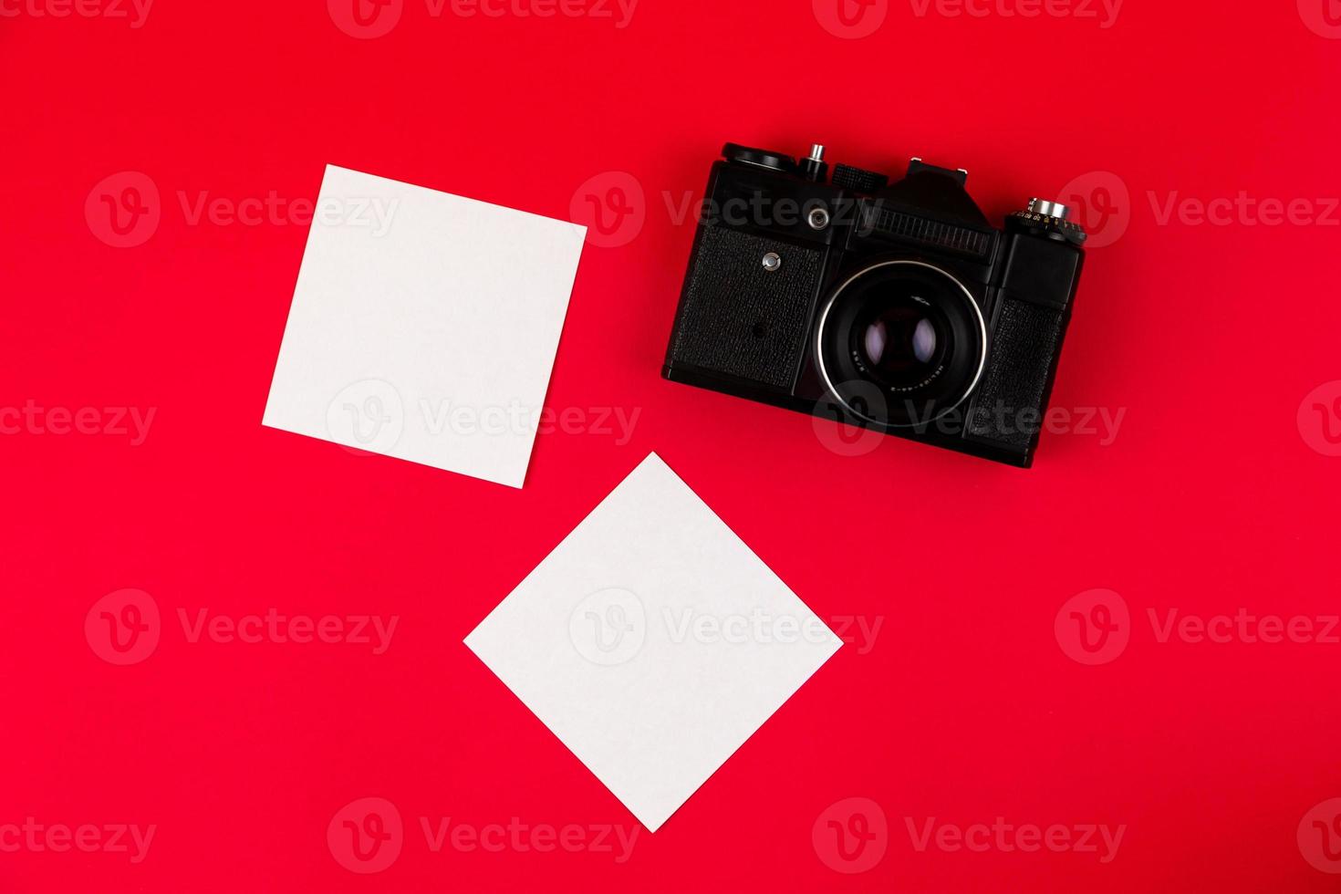 Flat lay film camera isolated on red background photo