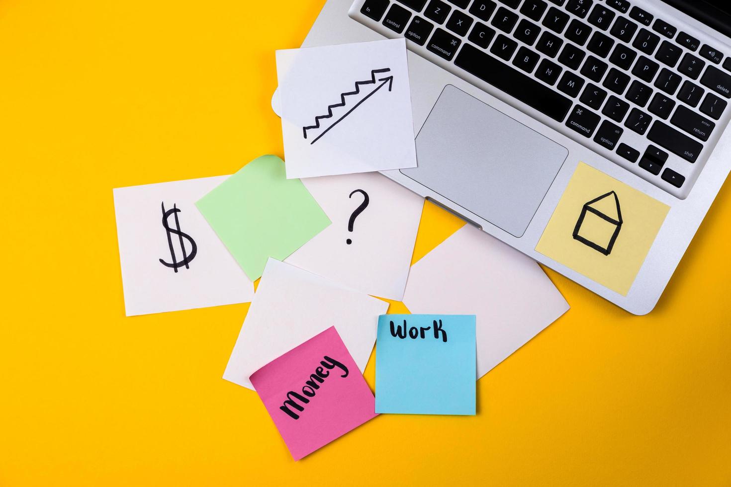 Home office desk workspace with laptop and paper sticker on yellow background photo