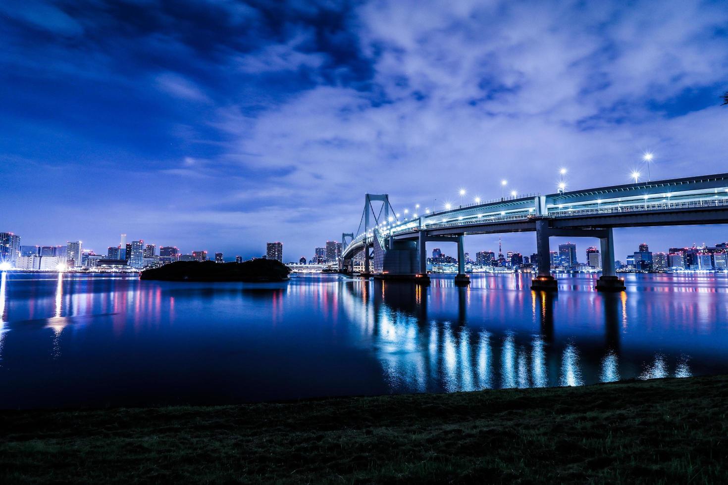 Tokyo night city scape in Odaiba with rainbow bridge photo