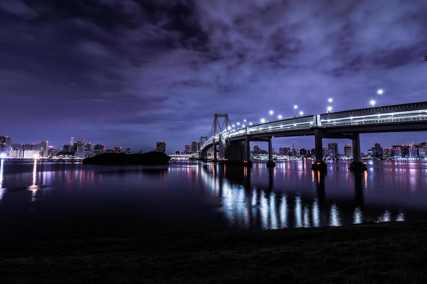 Tokyo night city scape in Odaiba with rainbow bridge photo