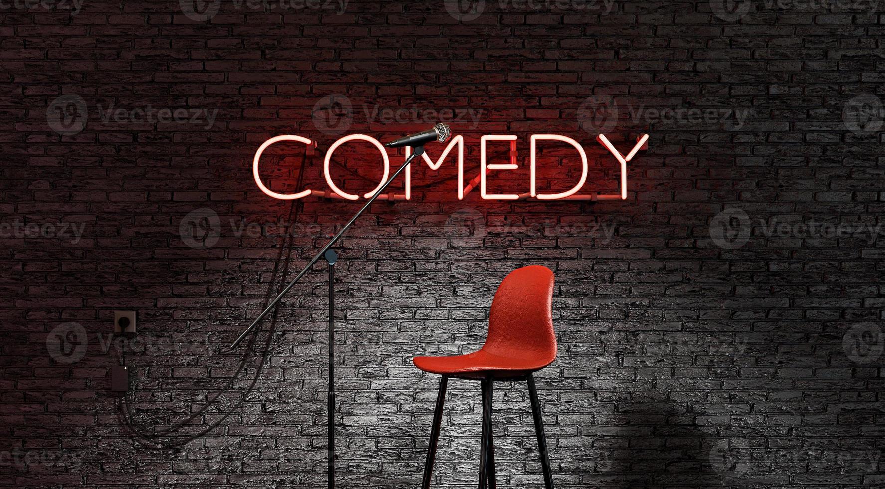 escenario iluminado por un foco y una lámpara de neón roja con la palabra comedia foto