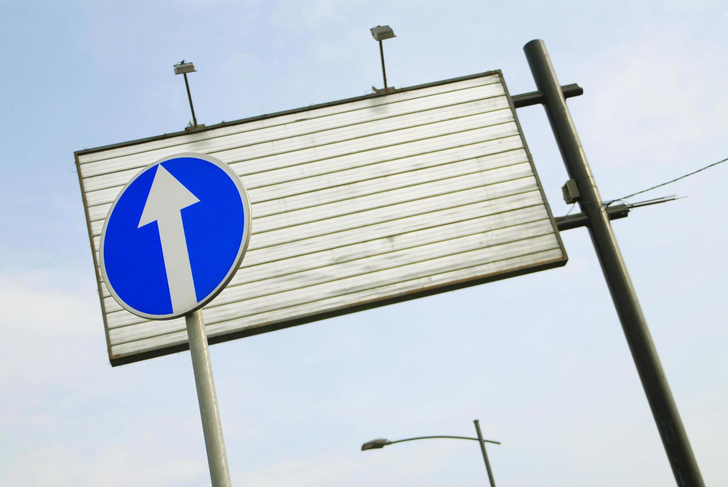 A road sign and an empty billboard photo