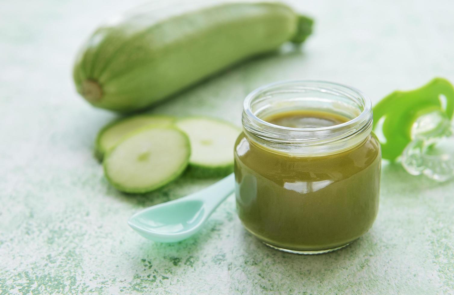 Jar with healthy baby food and zucchini photo