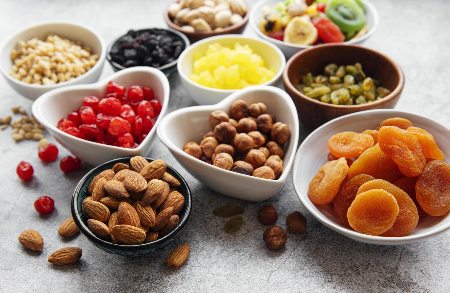 Bowls with various dried fruits and nuts photo