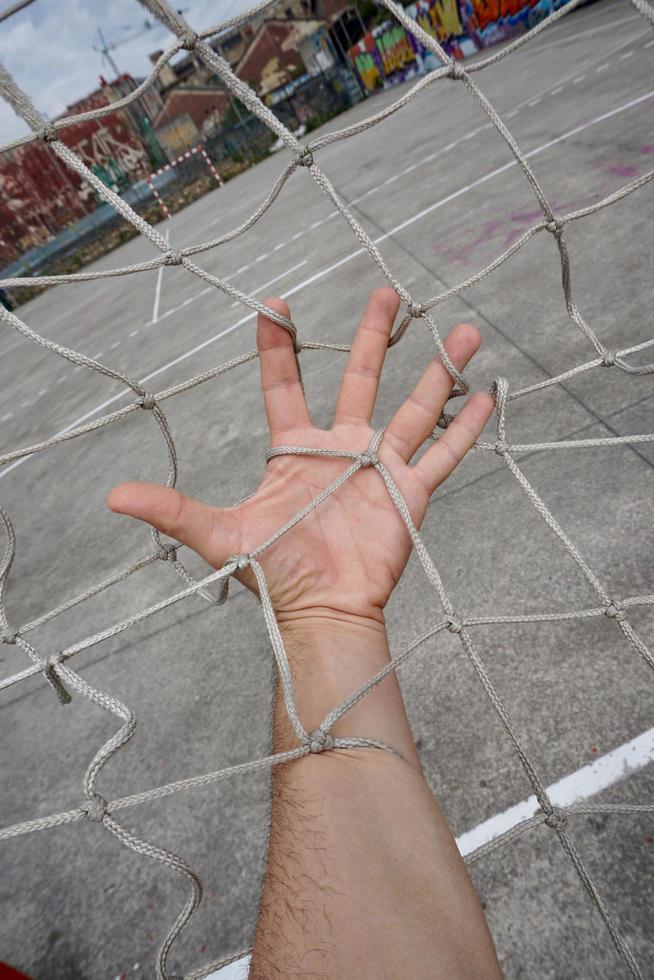 hand touching a rope net photo