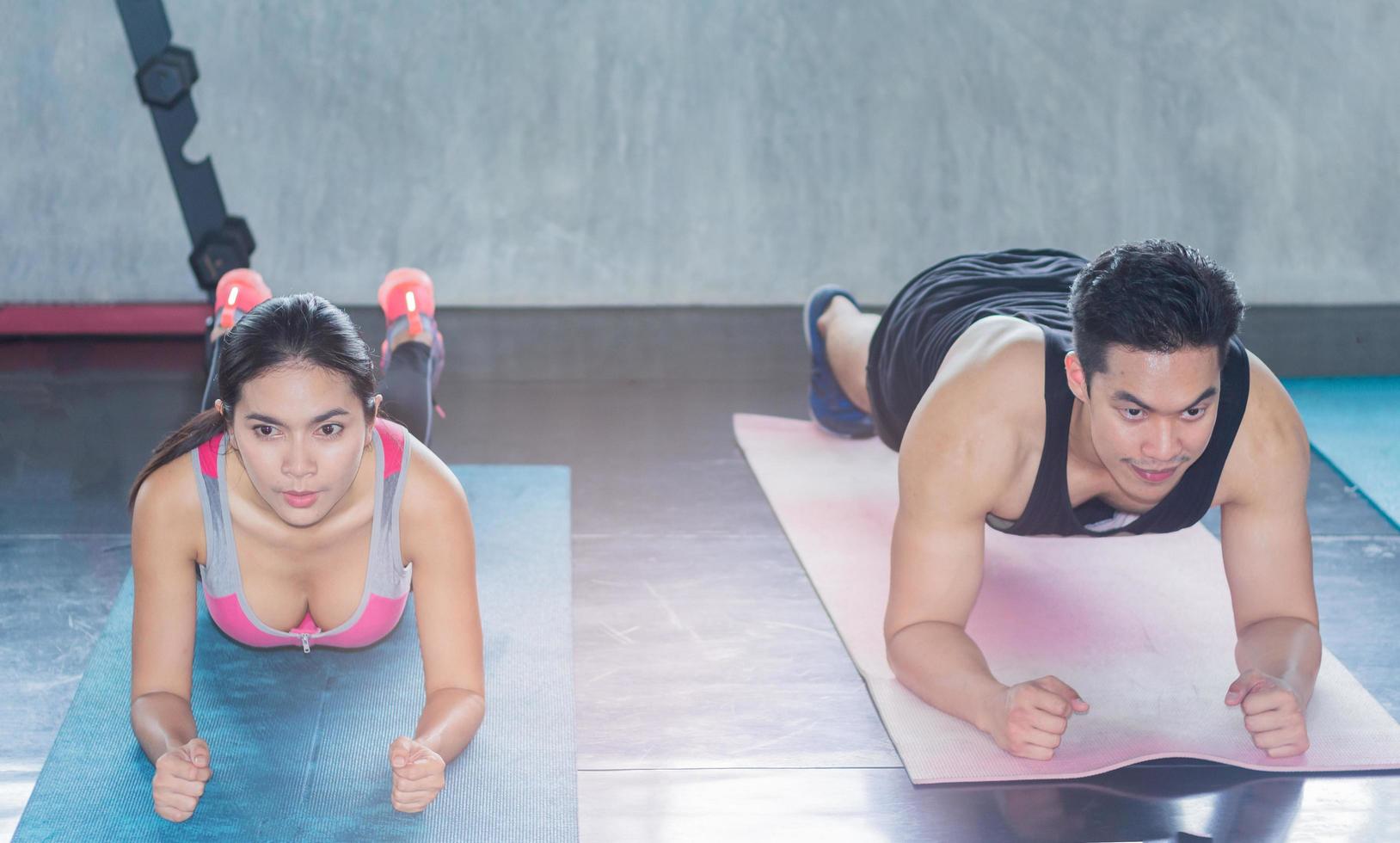 Young people exercises in the gym photo