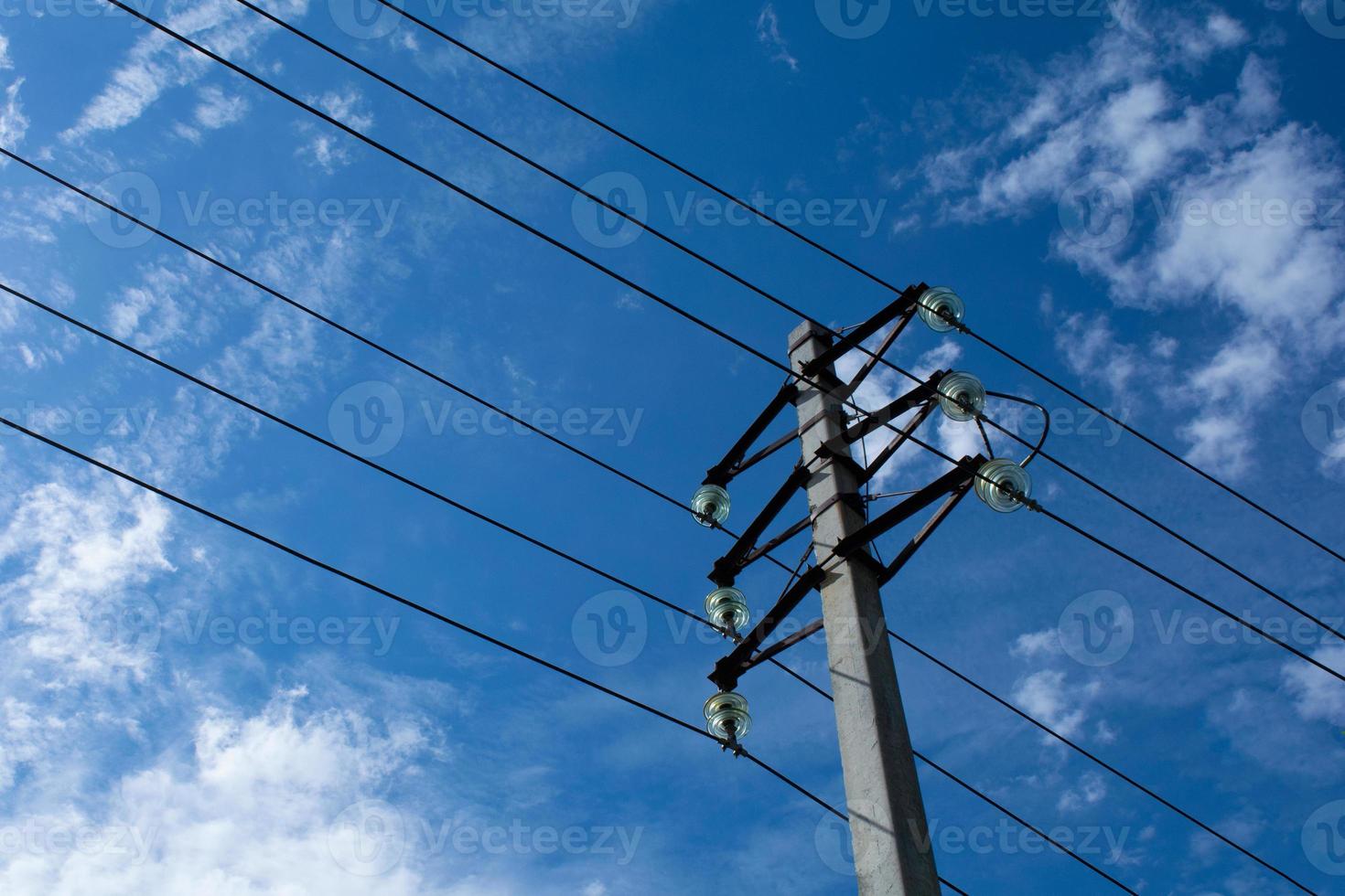 post with wires early in the morning against the sky photo