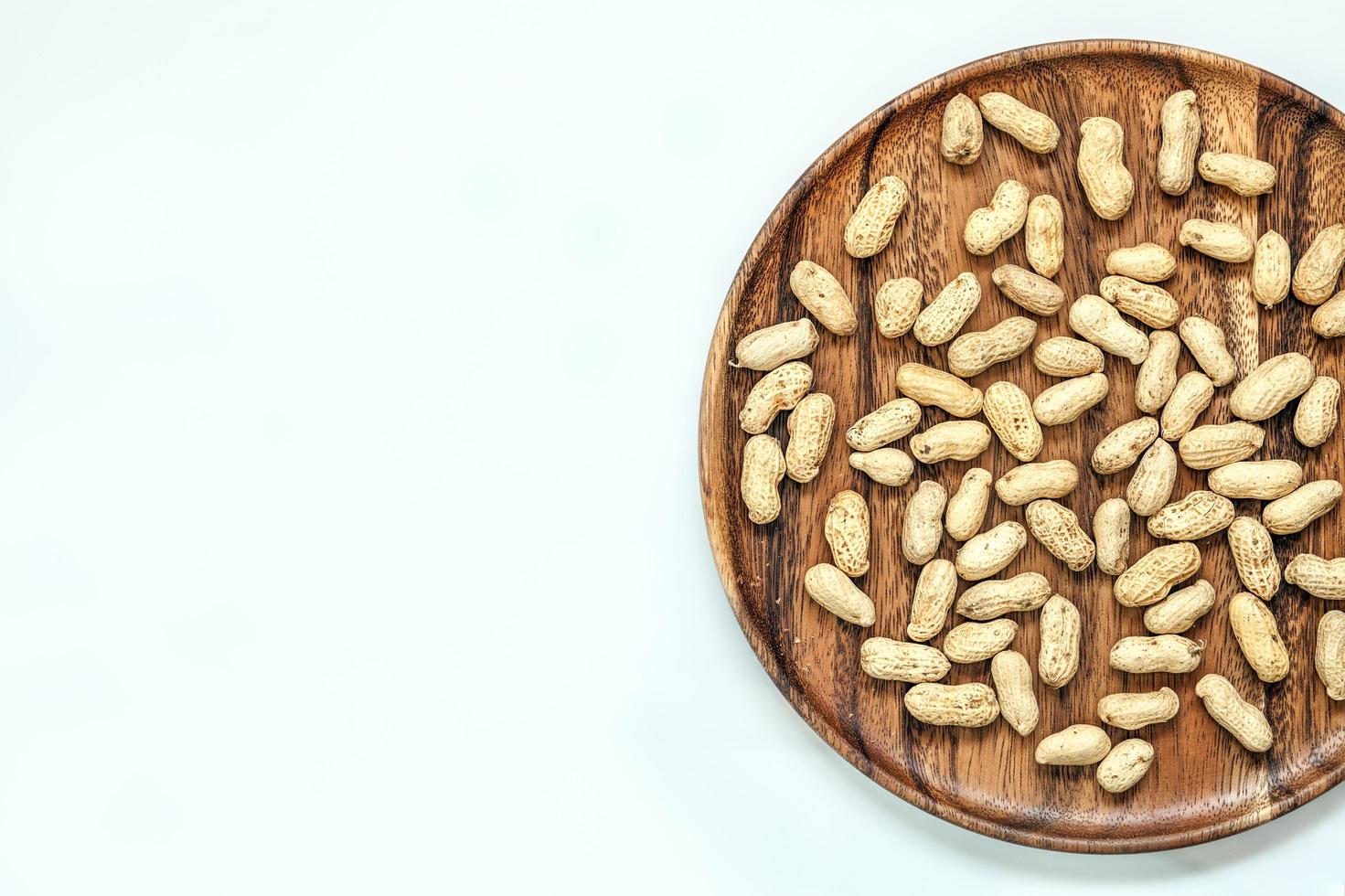 Roasted peanuts on wood disk photo