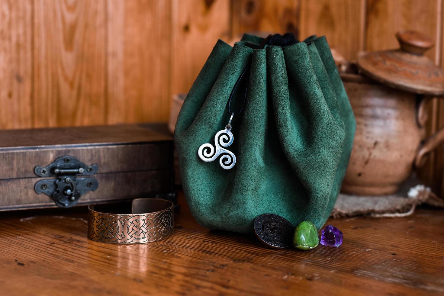 Green leather pouch with Celtic Triskele Symbol photo