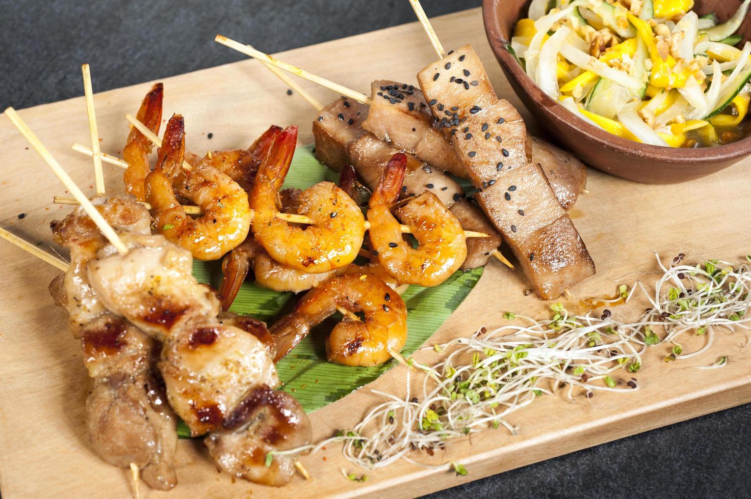 Mixed skewers chicken fish and cow meat photo
