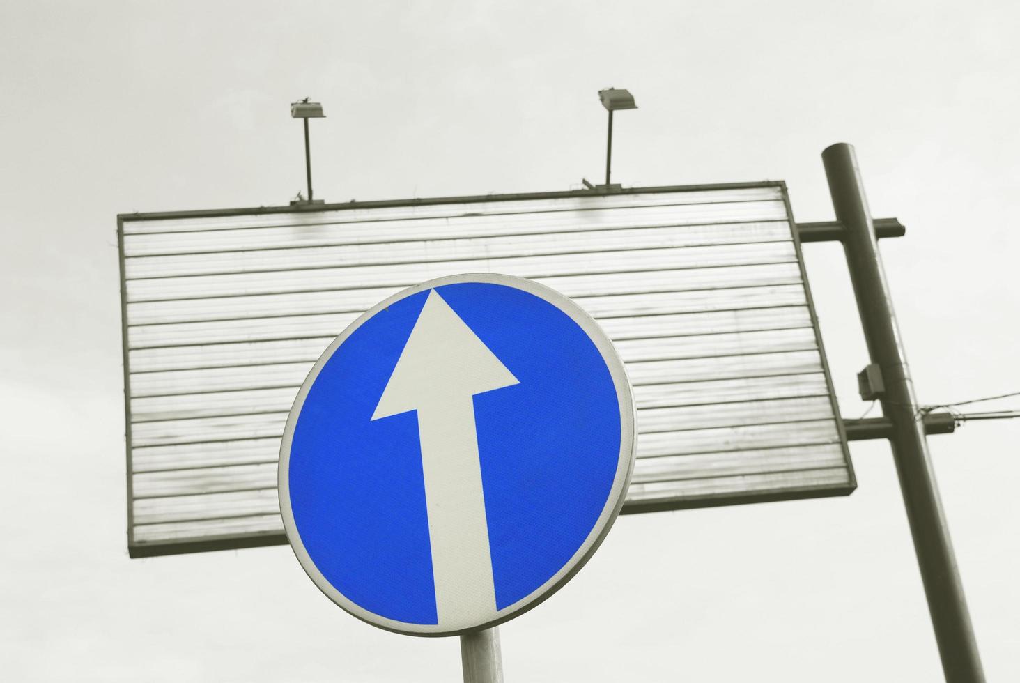 A road sign and an empty billboard photo