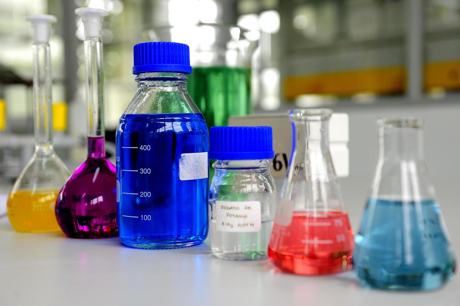 Laboratory glassware containing colorful chemical liquid photo