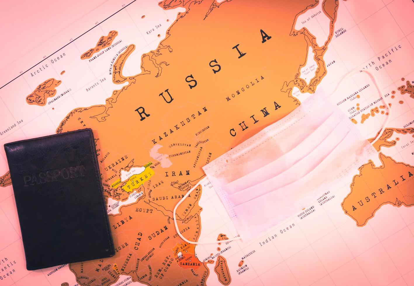 Map with passport and face mask photo