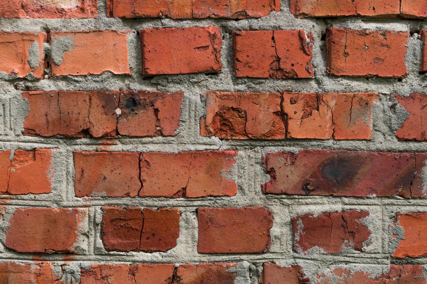 Old wall background with stained aged red bricks photo