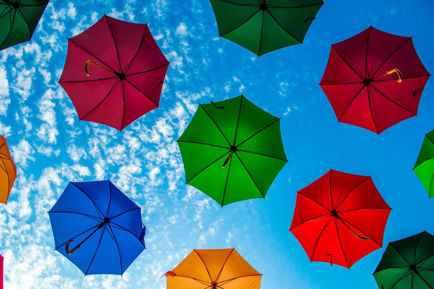 Multi colored umbrellas with blue sky photo