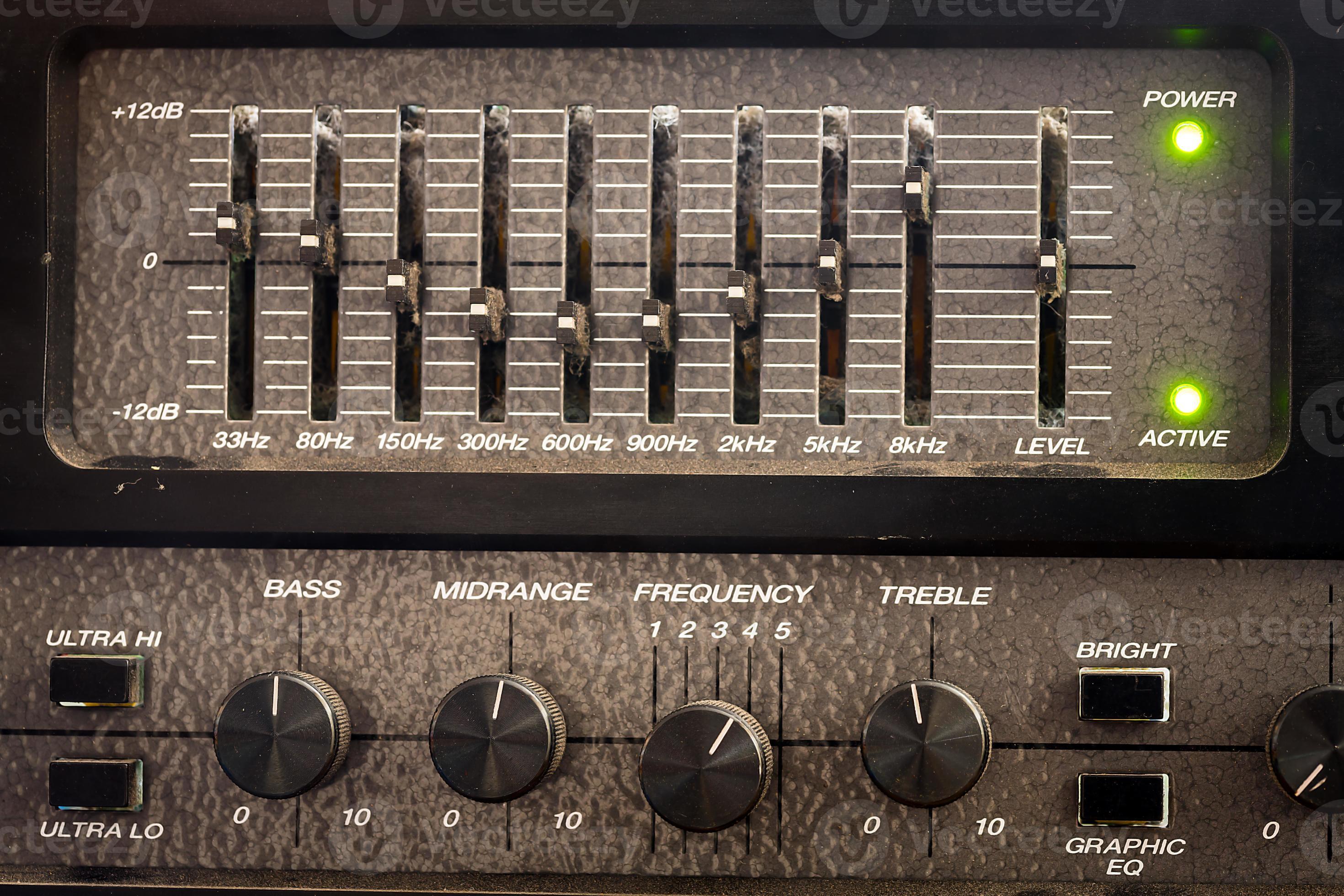 Old black controls of an audio equalizer from a guitar amplifier