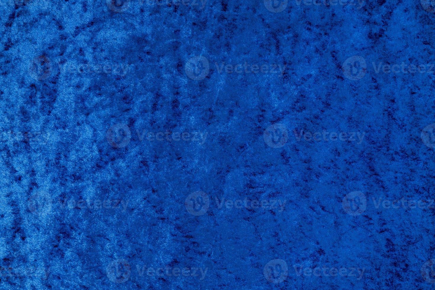 Dark blue shiny even velvet fabric as a background photo