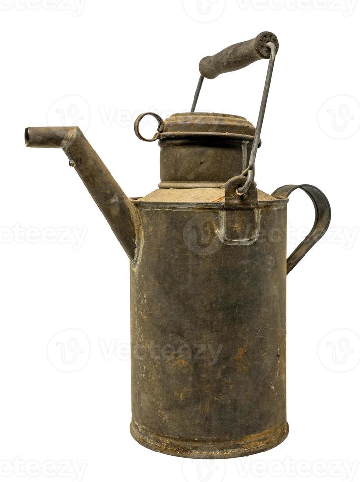 Old dirty oil can of tin with carrying handle isolated on white photo