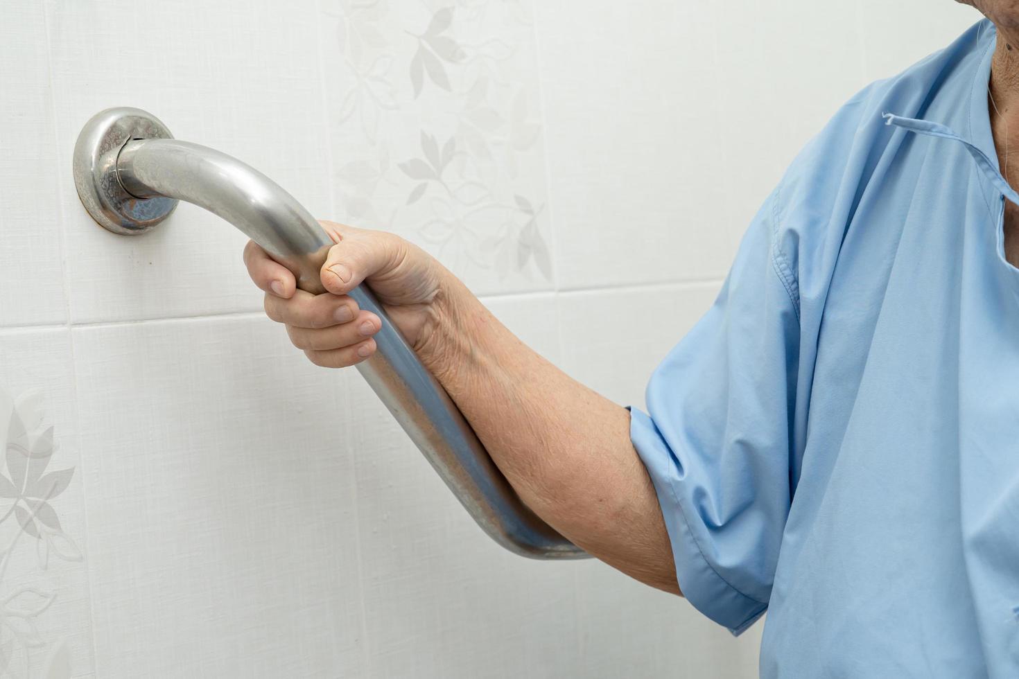 Asian senior or elderly old lady woman patient use toilet bathroom handle security in nursing hospital ward healthy strong medical concept photo