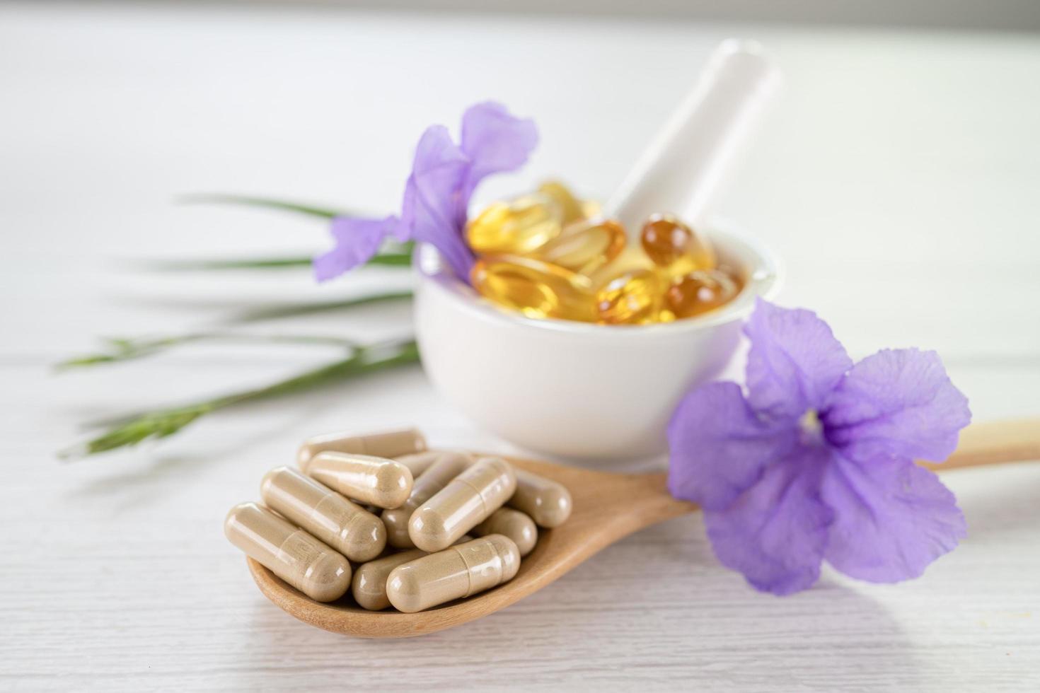 Alternative medicine herbal organic capsule with vitamin E omega 3 fish oil mineral drug with herbs leaf natural supplements for healthy good life photo