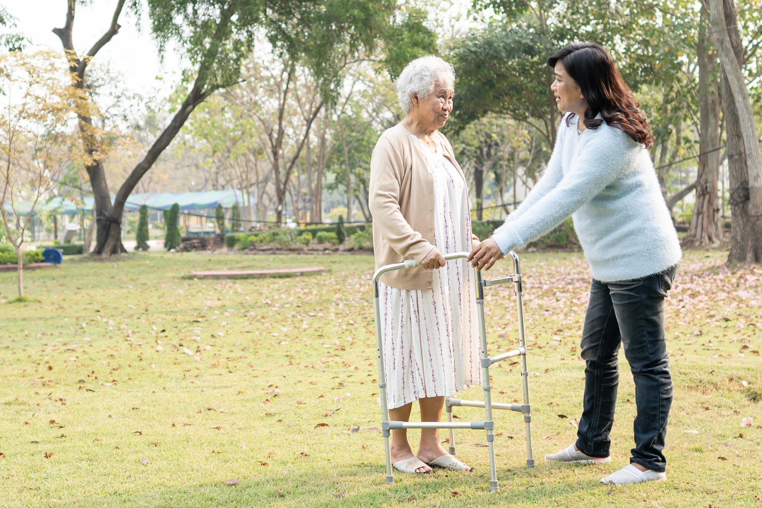 Help and care Asian senior or elderly old lady woman use walker with strong health while walking at park in happy fresh holiday 2447362 Stock Photo at Vecteezy