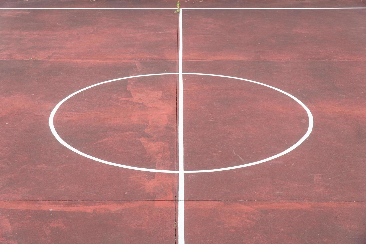 Multi sport game court with aged red floor photo
