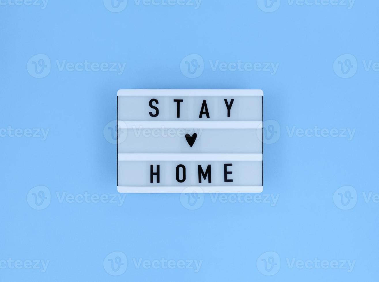 Light box with Stay home quote on a blue background photo