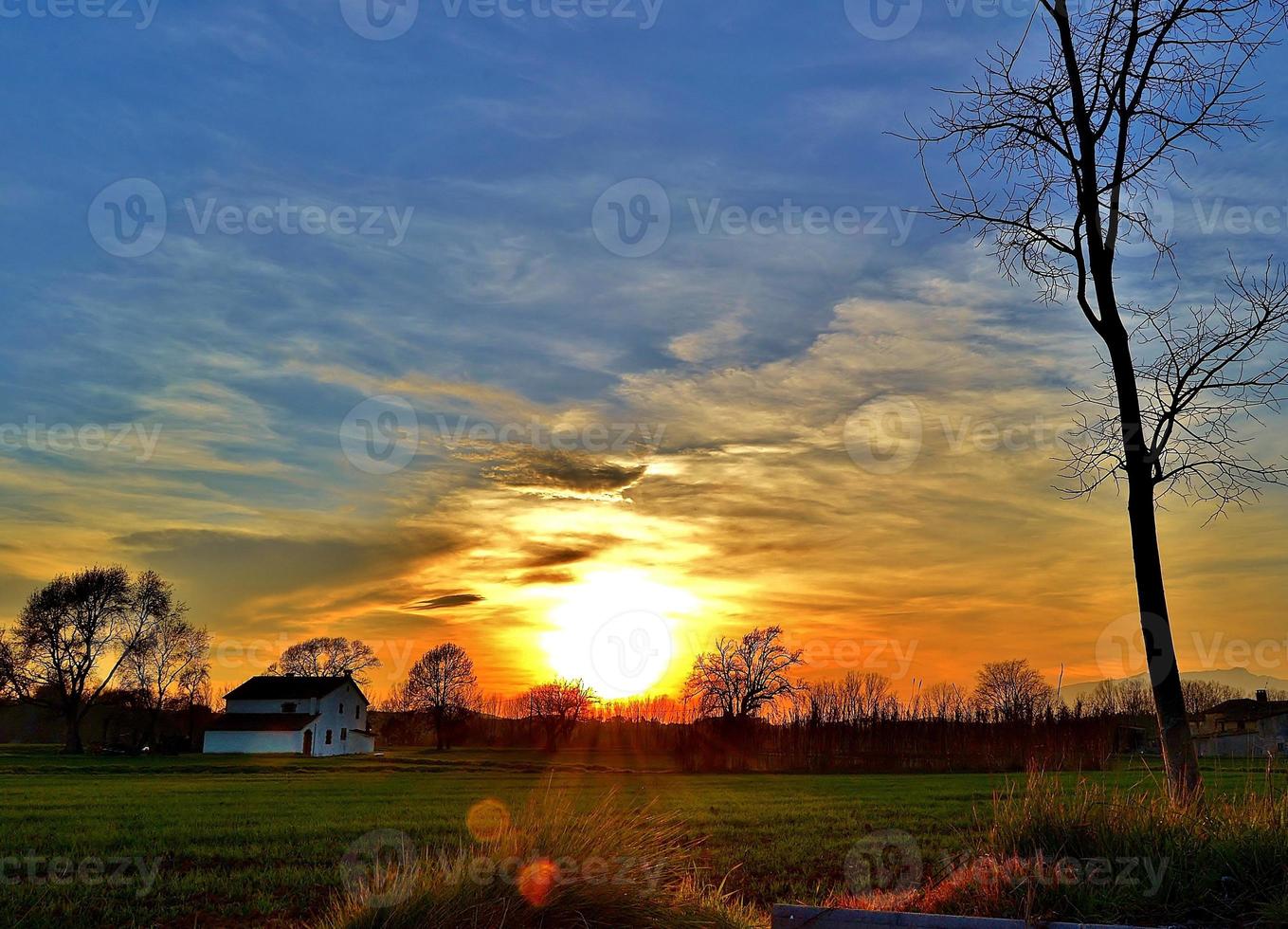 White country house at sunset with blue sky photo