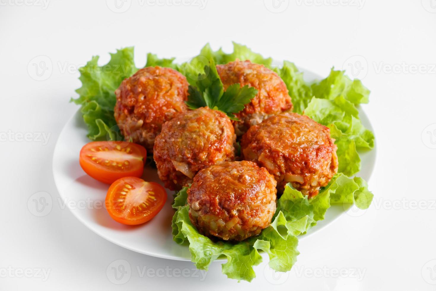 Meat balls in tomato sauce isolated on a white background photo