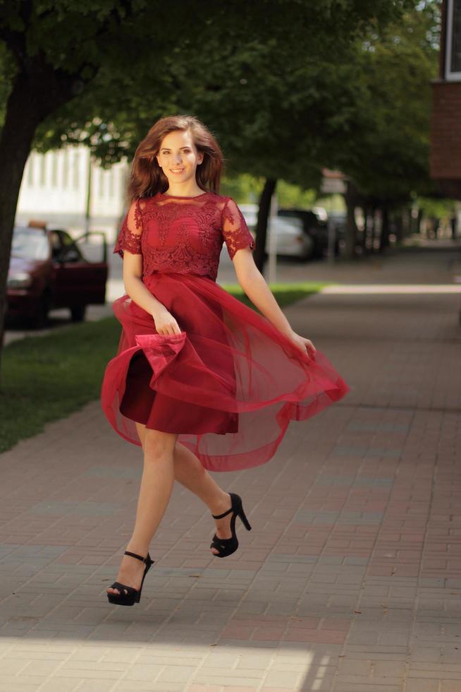 Girl running in heels on pavement photo