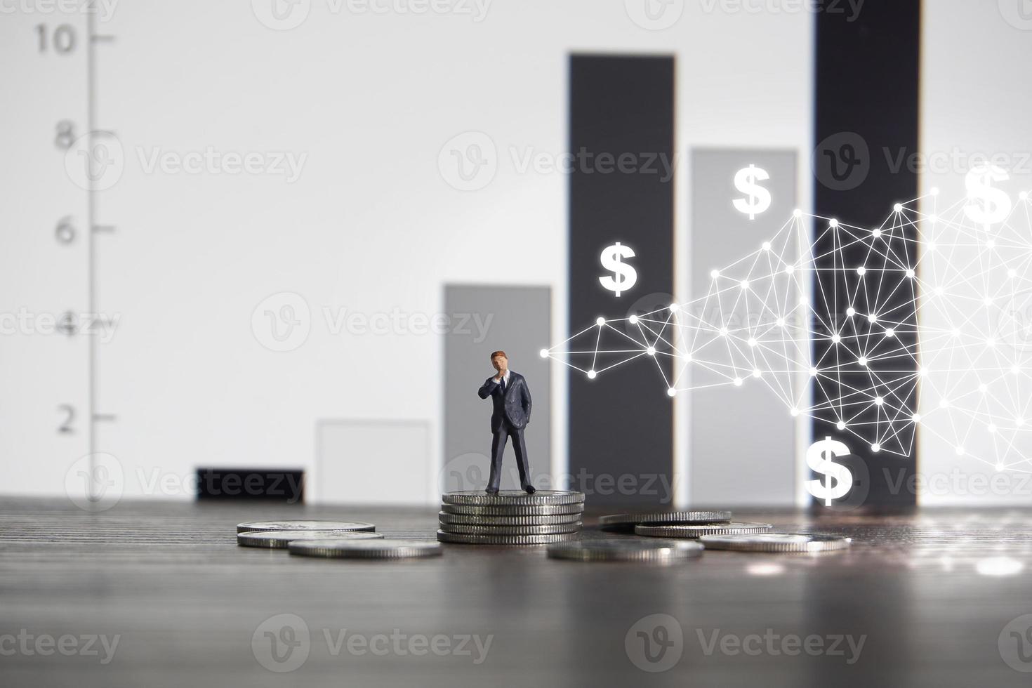 Business concept Businessman standing on a pile of silver coins photo