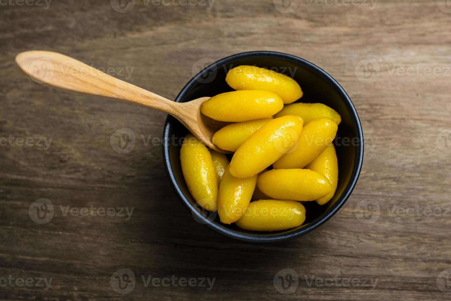 Thai traditional desserts Mung bean paste formed in egg yolk and sugar in black small bowl on the Wooden top table photo