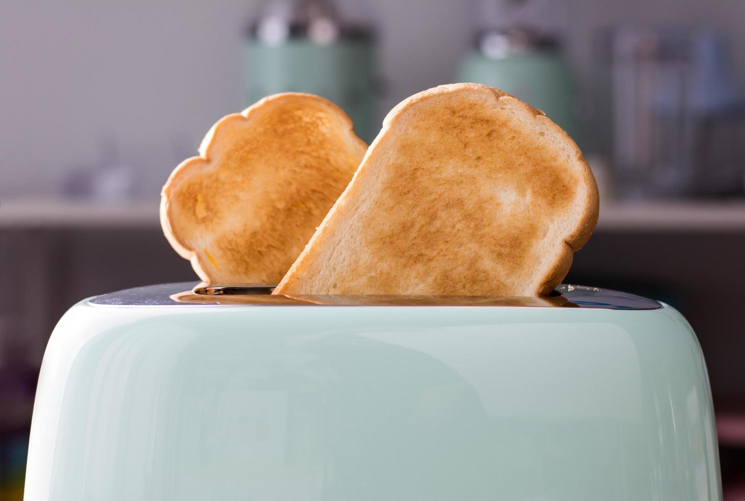 Close up of Bread slices in a green toaster photo