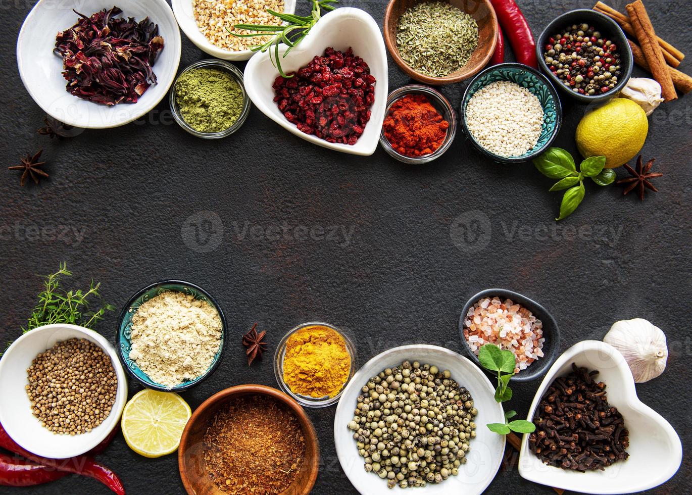 Various spices in a bowls on a black photo