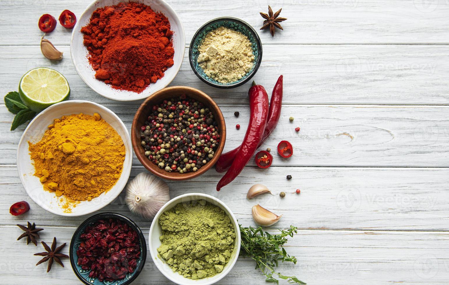 Various spices  on white wooden background photo