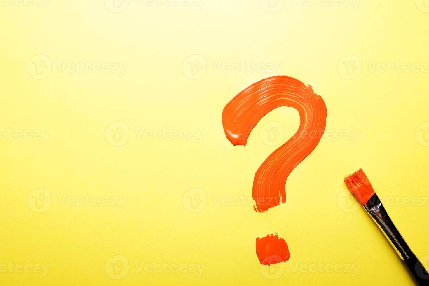 A painted question mark on yellow paper photo