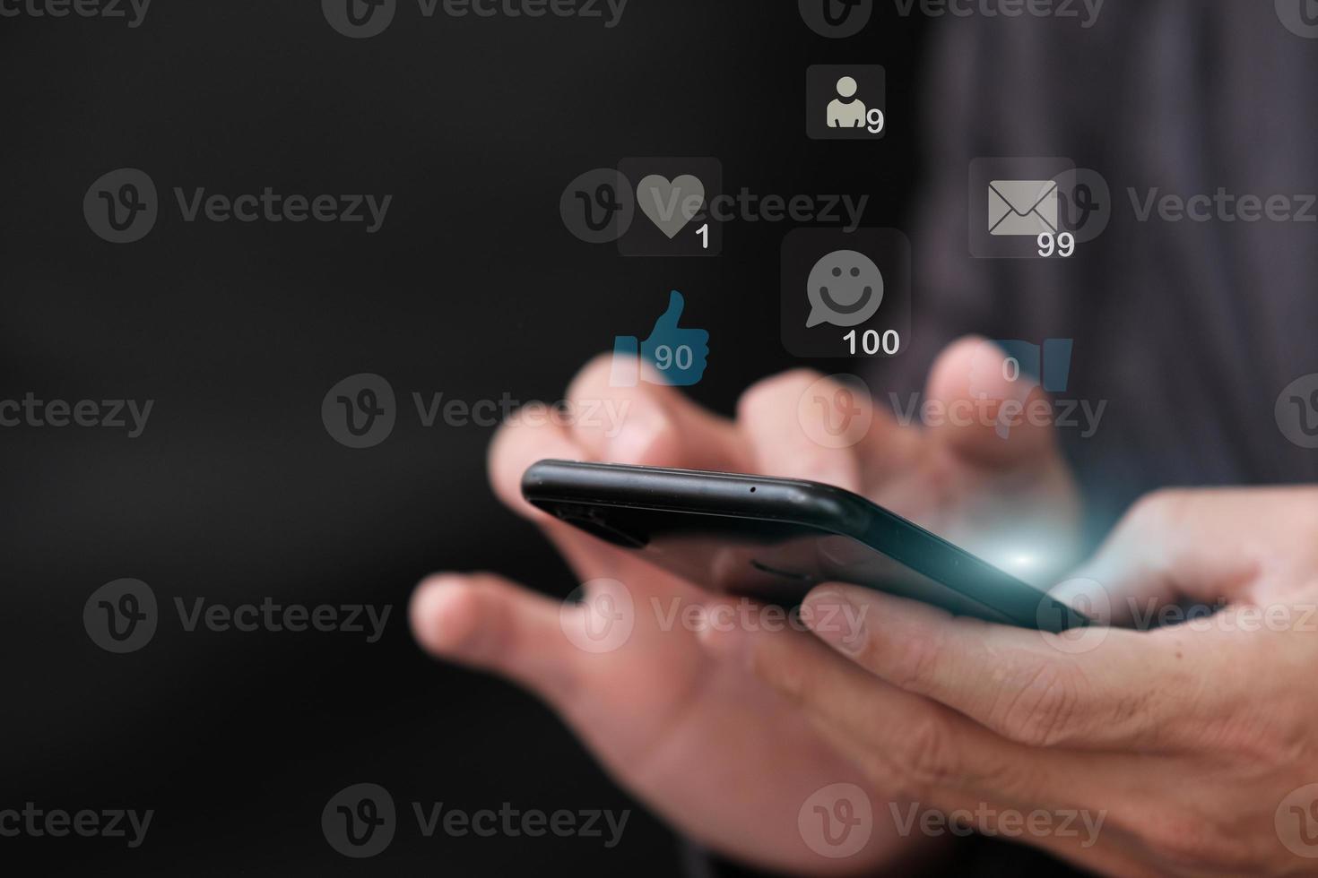 Person using smartphone social media network interactions concept with icons of comments photo