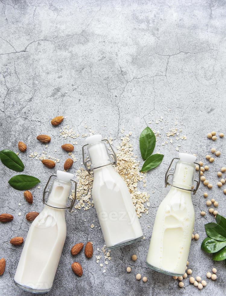 Bottles with different vegetable milk photo