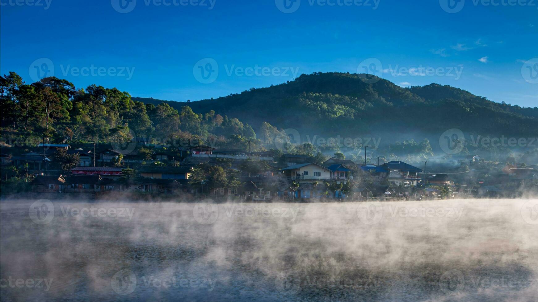 Rakthai village with mist from lake in morning at Mae Hong Son, Thailand photo