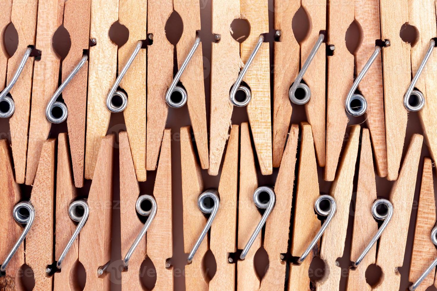 Macro old wooden clothespins background photo