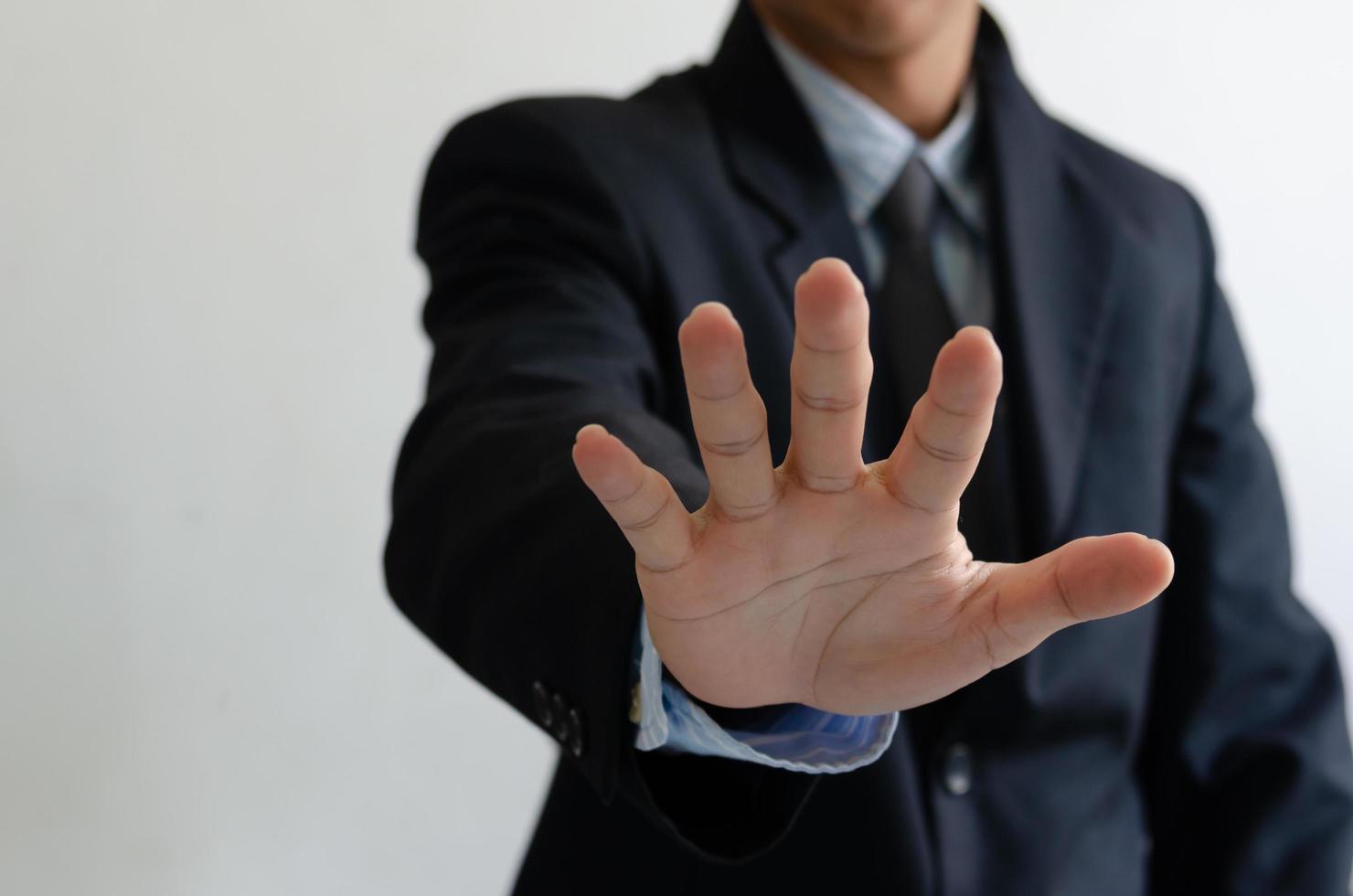 Businessman wearing a suit raised five fingers photo
