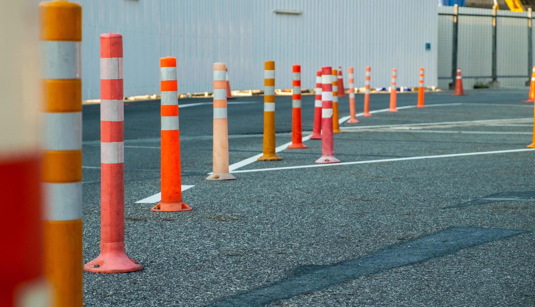 Orange traffic pole on asphalt road in parking lot photo