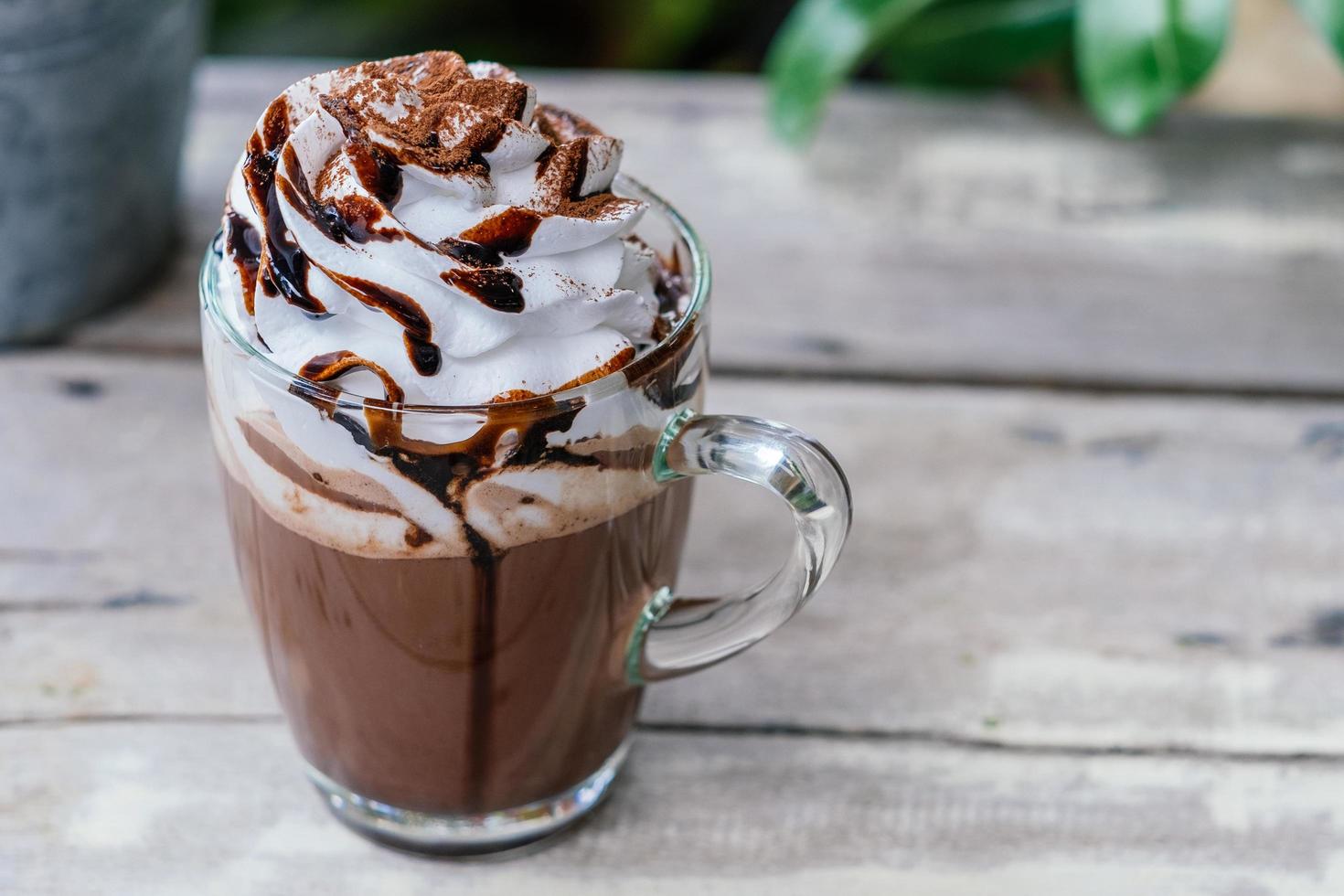 Hot chocolate cocoa in glass mug with whipped cream photo