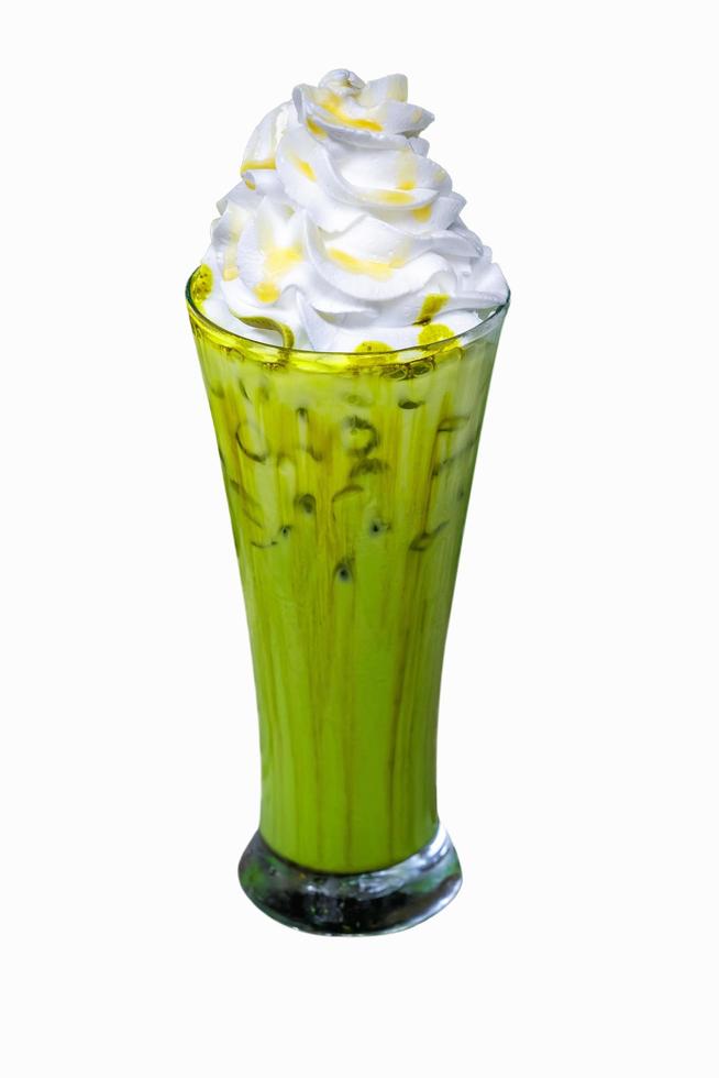 Iced matcha green tea with whipped cream in tall glass isolated on white background photo