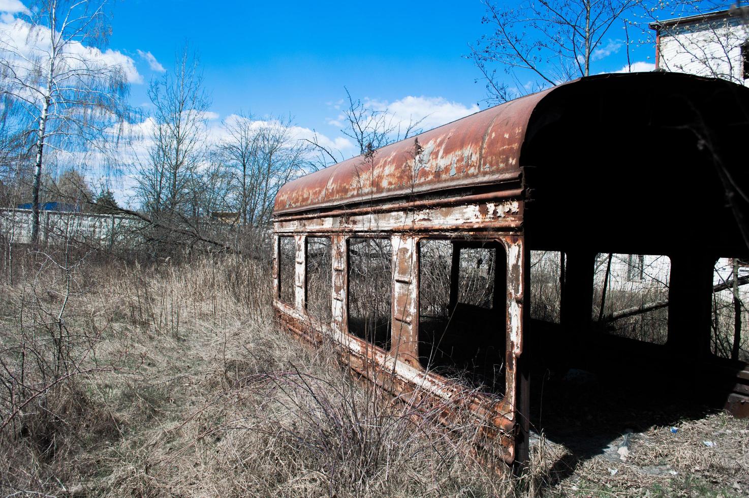 Old rusty carriage in dry grass photo