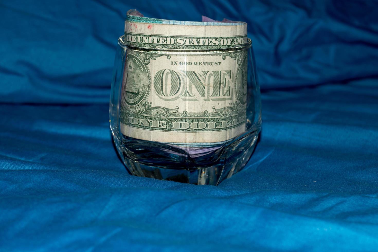 One dollar in a glass photo